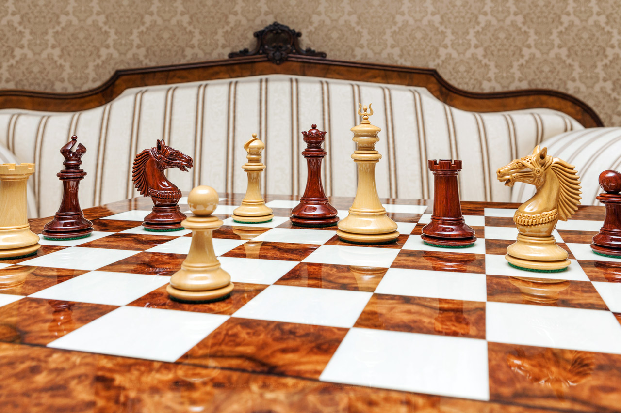 Wide view of Apollo lacquered padauk and boxwood chess pieces on the 60 cm Da Vinci chess board