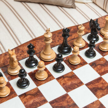 High-angle view of Apollo lacquered ebony and boxwood chess pieces on the 60 cm Da Vinci chess board