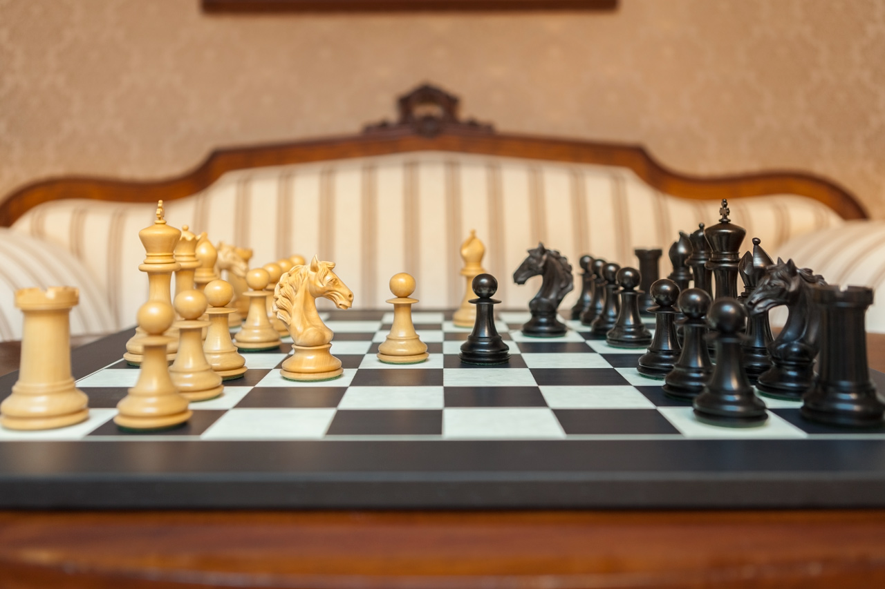 Florence ebony and boxwood pieces facing each other across the Asturias board