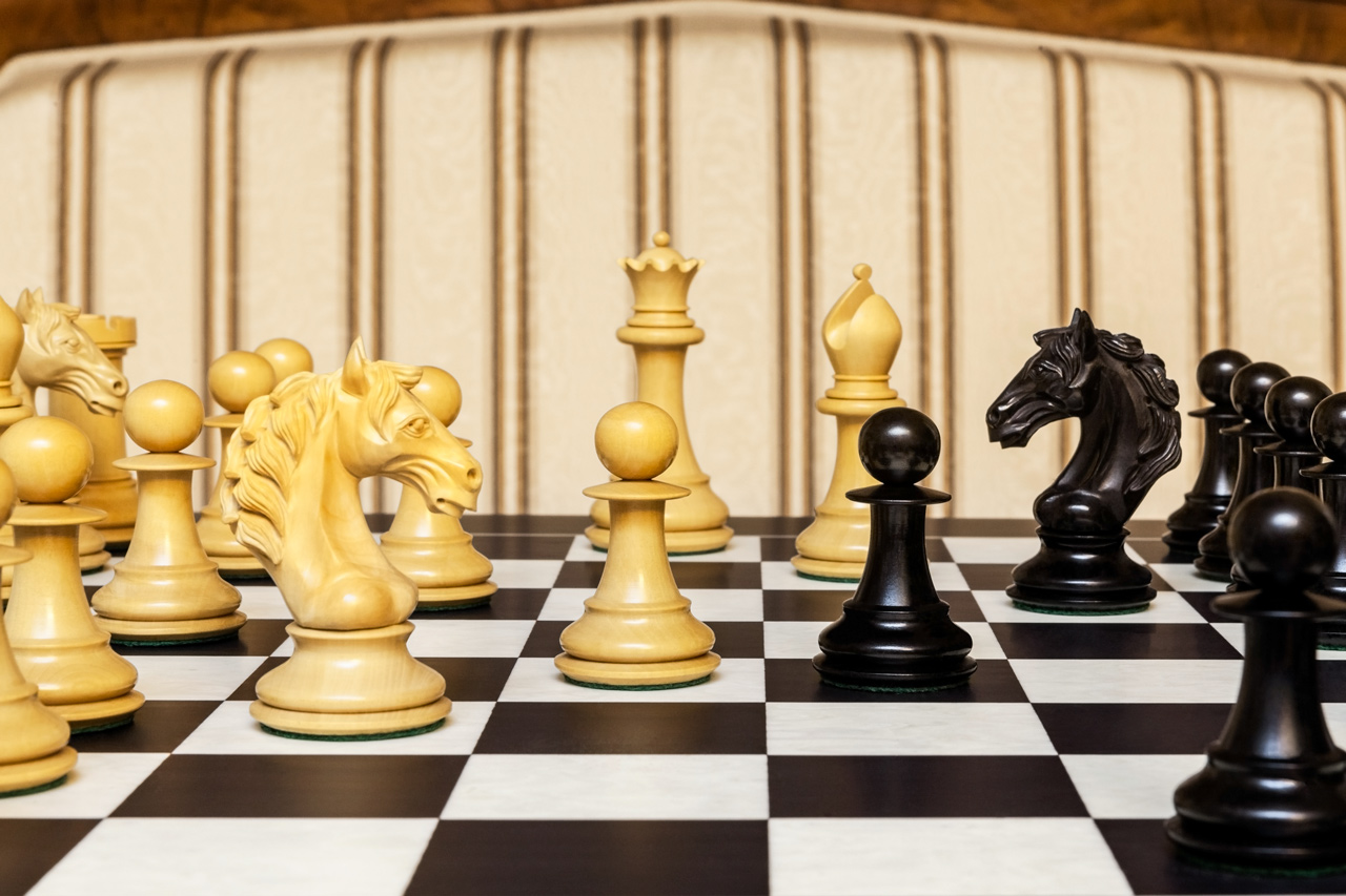 Close-up of Florence boxwood and ebony pieces on the Asturias board