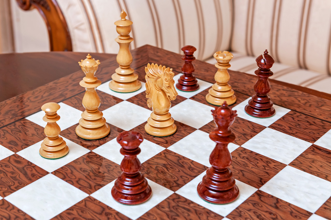 Dali padauk and boxwood pieces in a game position on the Segovia board