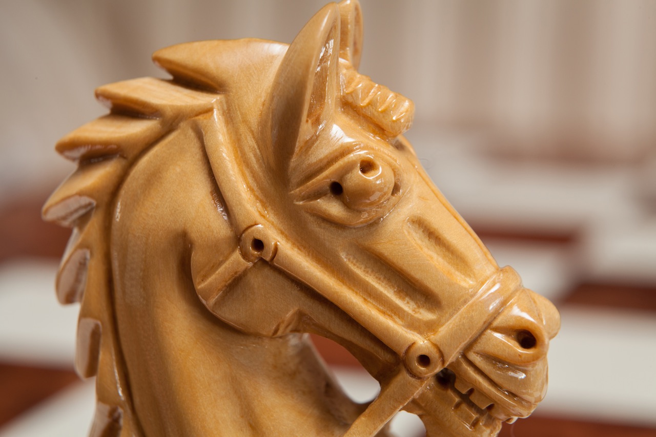 Close-up of a carved Regal knight in lacquered boxwood