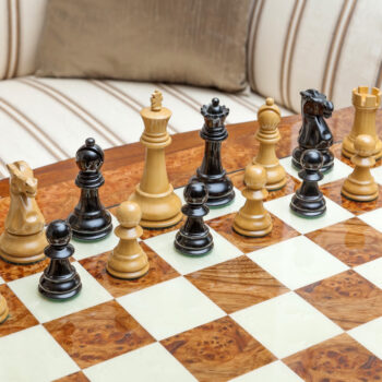 Shown with: 51 cm Venezia chess board High-angle view of Viking lacquered boxwood and ebony chess pieces during play on the 51 cm Venezia chess board