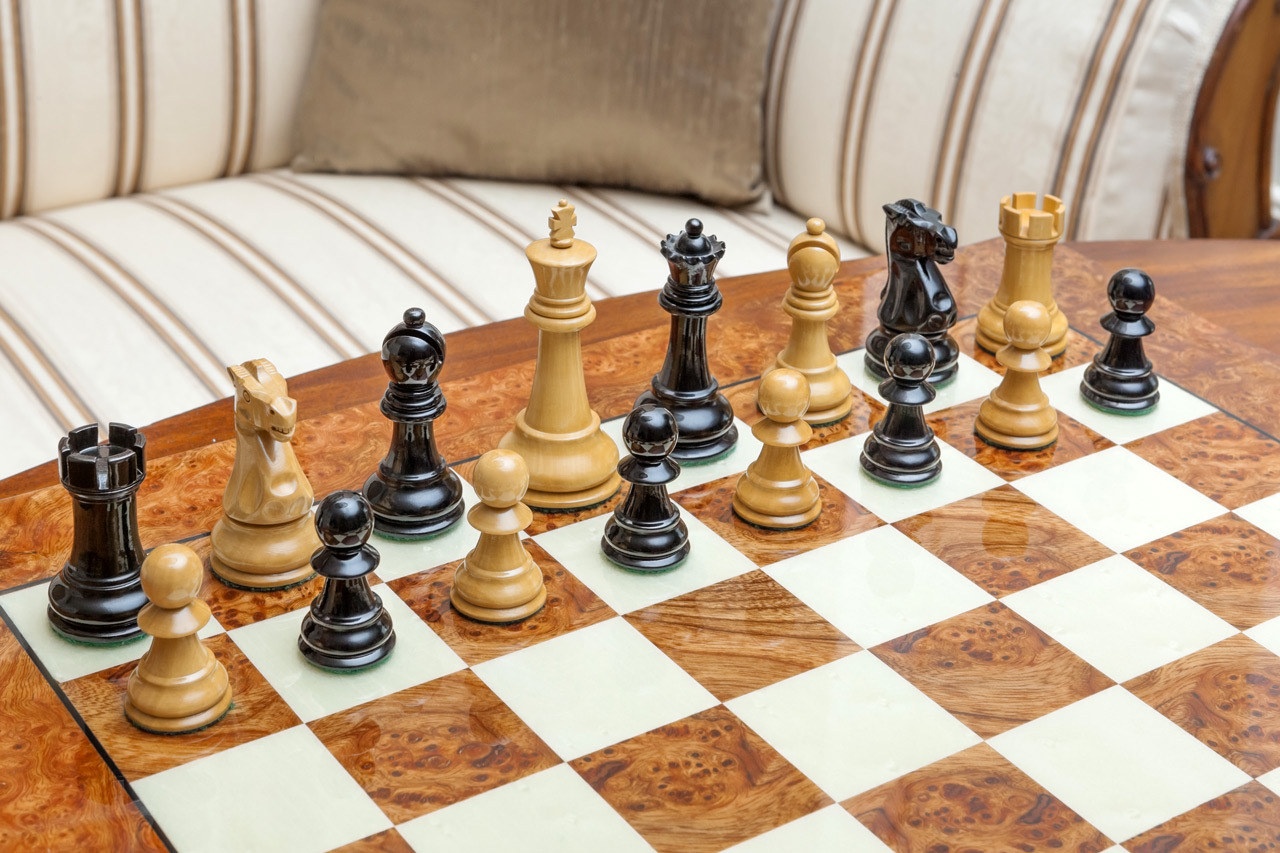 Shown with: 51 cm Venezia chess board High-angle view of Viking lacquered boxwood and ebony chess pieces during play on the 51 cm Venezia chess board